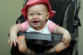 happy baby in stroller